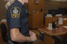 Sheriff standing in courtroom.