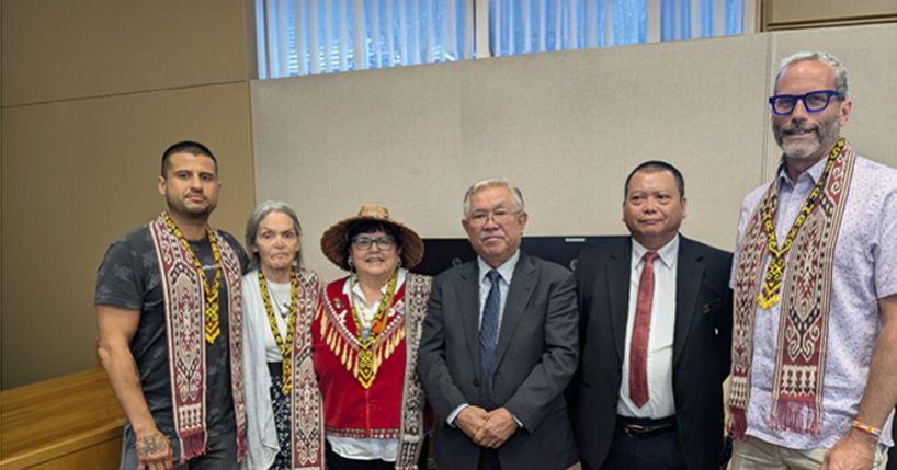Judges standing with Malaysian delegation.