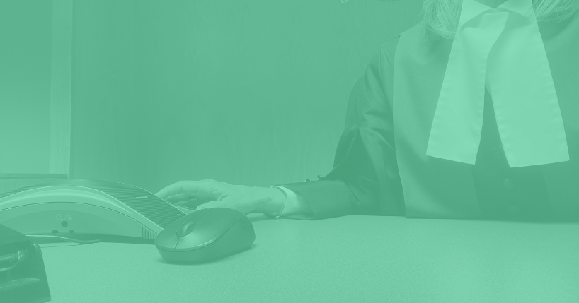 Judicial justice sitting at the bench with computer mouse next to hand.