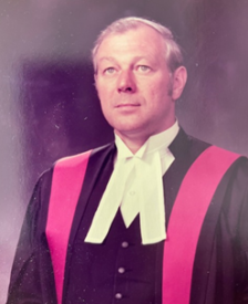 Older photo of Judge MacAlpine in judge's robes.