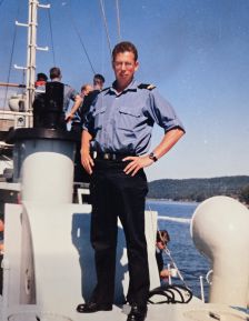Judge Reeves standing on deck of a naval ship.