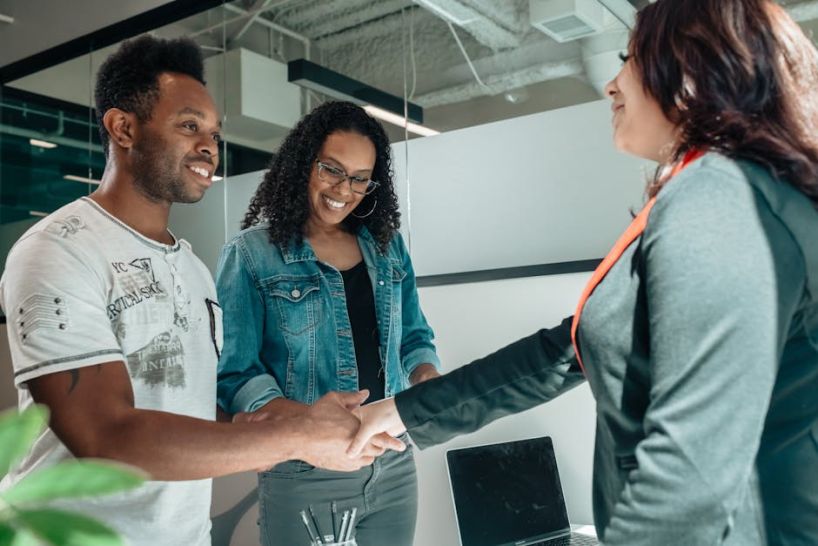 parenting coordinator shaking hands with two people