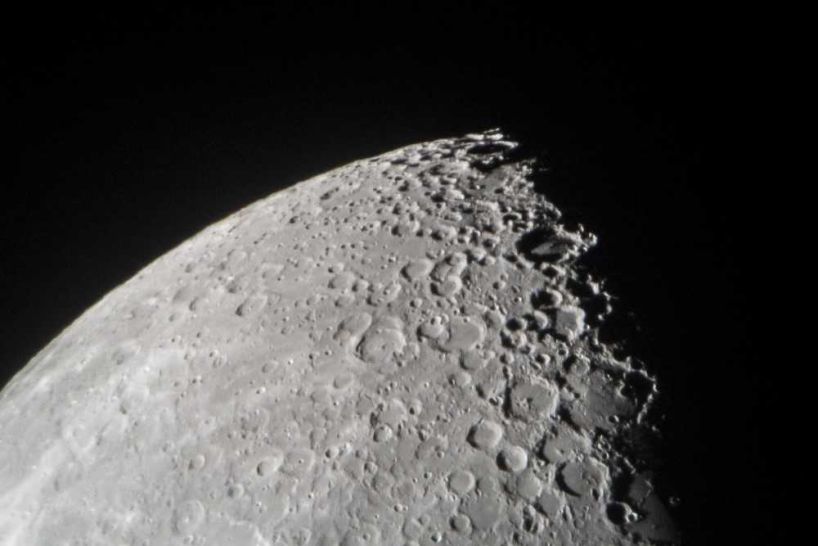 portion of the moon showing craters