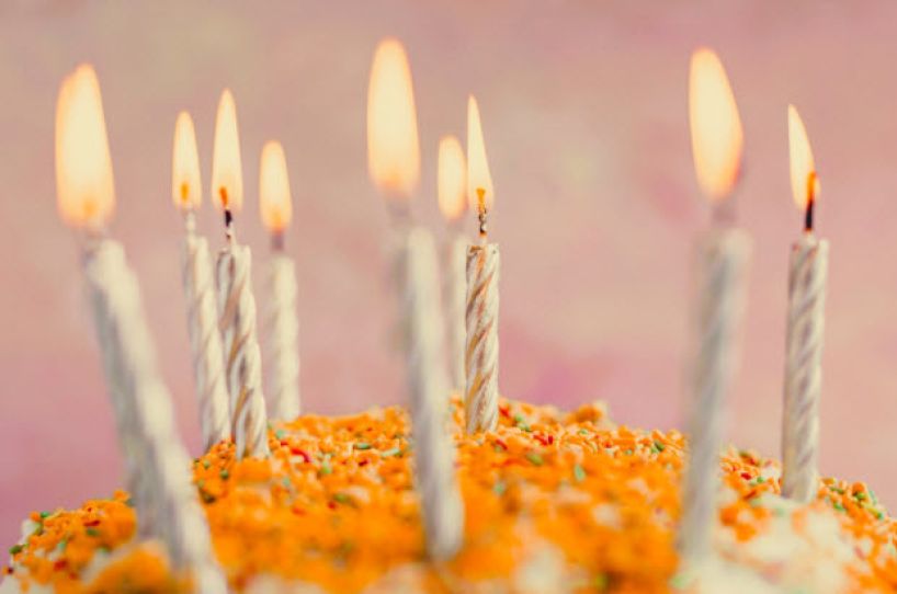 Lighted candles on a birthday cake.