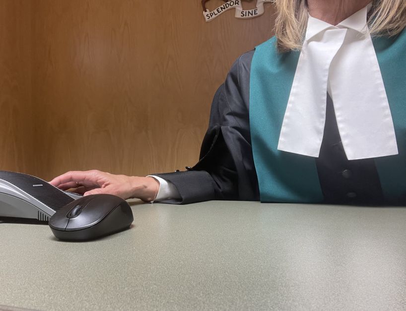 close up of judge in robes sitting at desk